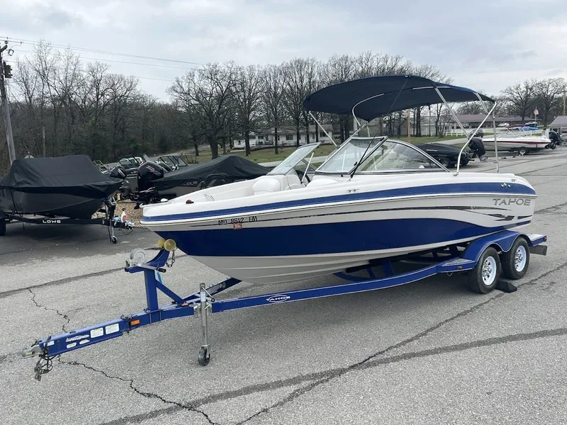 Slide: The Image of 2008 Tahoe Q7SI boat on trailer parked outdoors. - 5