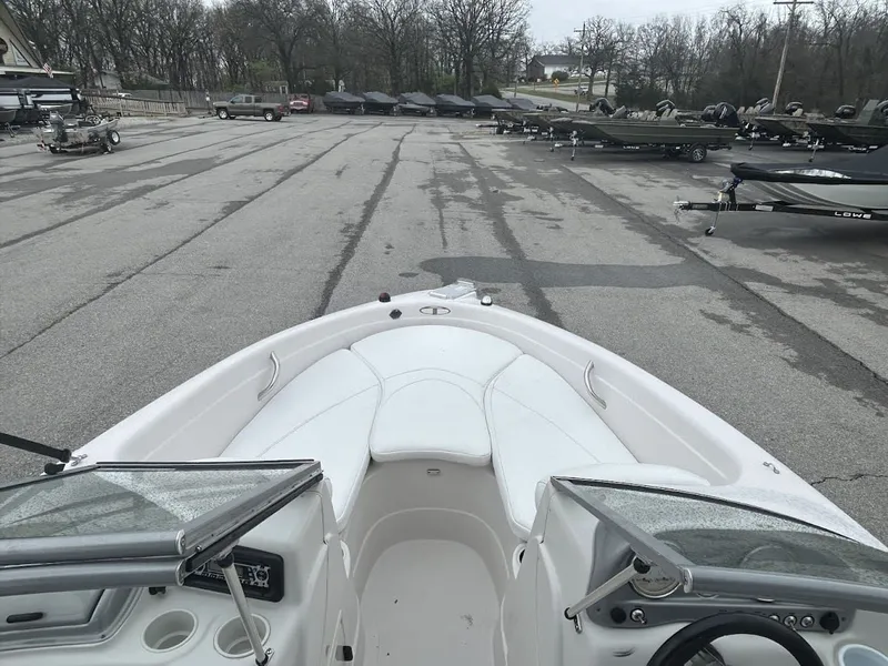 Slide: The Image of 2008 Tahoe Q7SI boat on parking lot with trailers. - 8