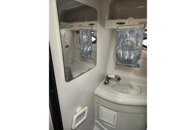 Slide: The Image of 2005 Crownline 275 CCR boat bathroom with sink, mirror, and storage. - 10