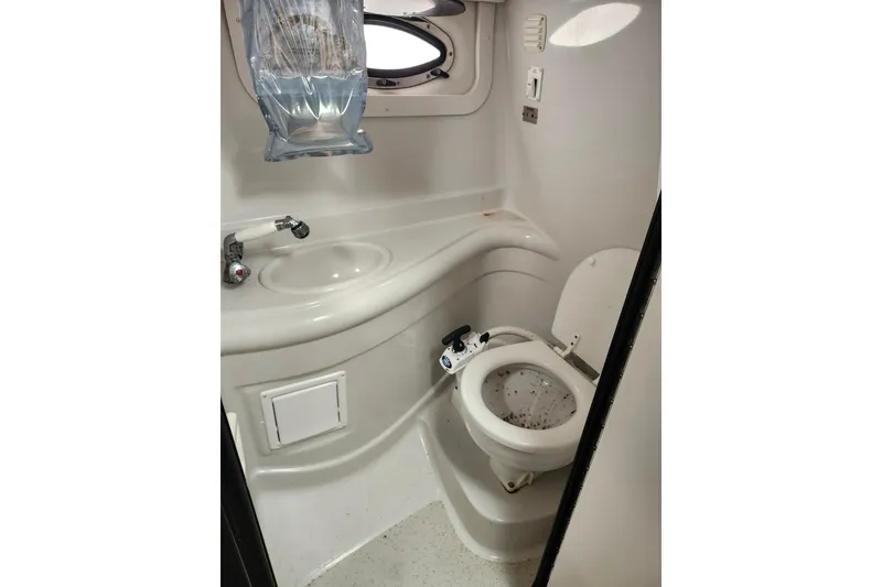 Slide: The Image of 2005 Crownline 275 CCR boat bathroom with sink and toilet. - 11