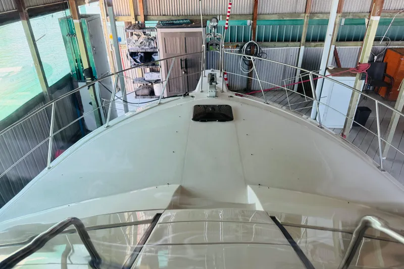 Slide: The Image of 1989 Carver 38 Santego yacht docked in a covered marina, view from the bow. - 14