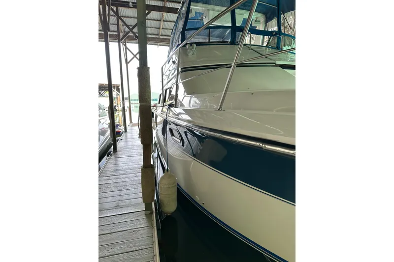 Slide: The Image of 1989 Carver 38 Santego yacht docked in a covered marina, side view. - 15