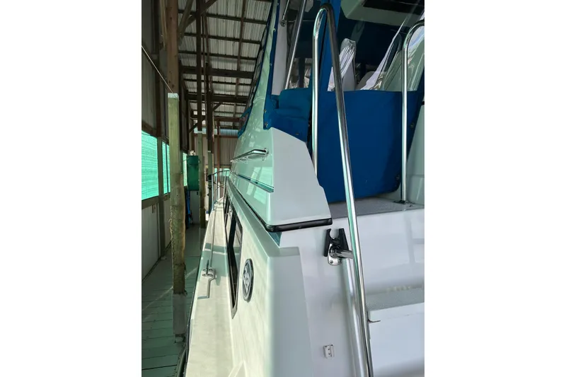 Slide: The Image of 1989 Carver 38 Santego yacht docked in a covered marina, side view. - 16