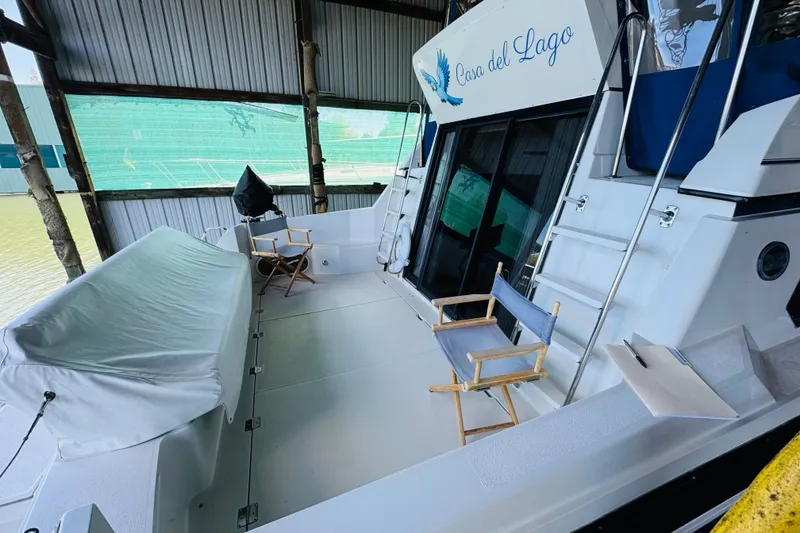 Slide: The Image of 1989 Carver 38 Santego yacht deck with chairs and covered seating area. - 19