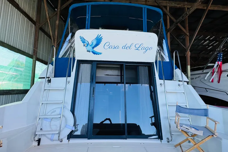 Slide: The Image of 1989 Carver 38 Santego yacht "Casa del Lago" docked in a marina with blue accents. - 24
