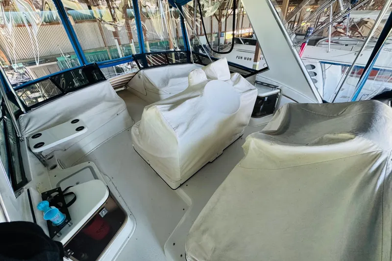 Slide: The Image of 1989 Carver 38 Santego yacht interior with covered seating and helm station. - 25