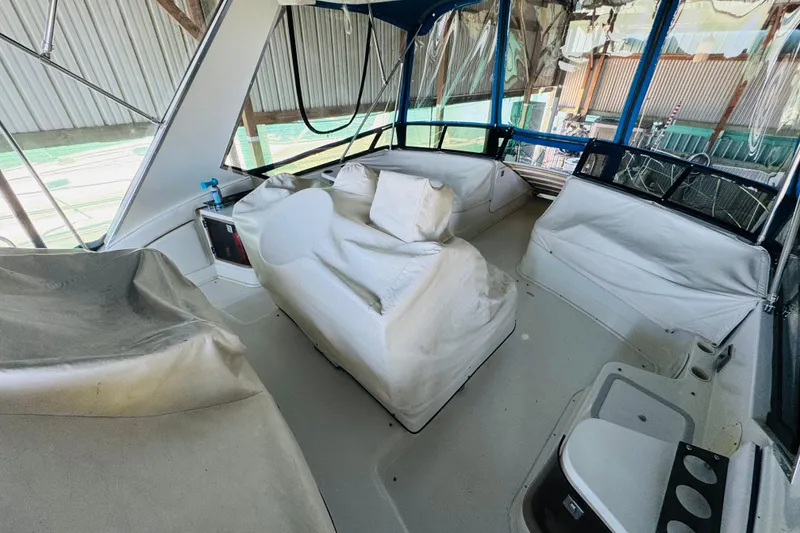 Slide: The Image of 1989 Carver 38 Santego boat interior with covered seating and helm area. - 26
