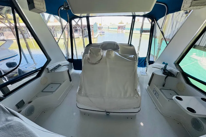 Slide: The Image of 1989 Carver 38 Santego yacht interior with covered seating, docked at marina. - 28