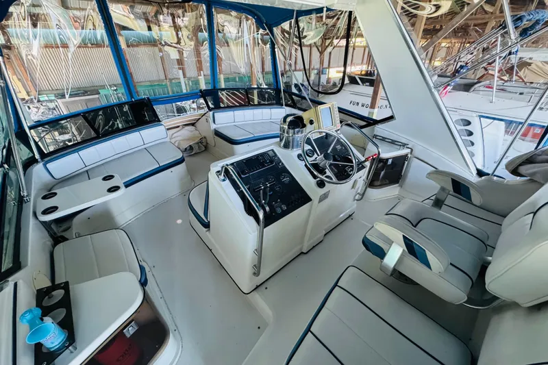 Slide: The Image of Interior of a 1989 Carver 38 Santego yacht with helm and seating area. - 29