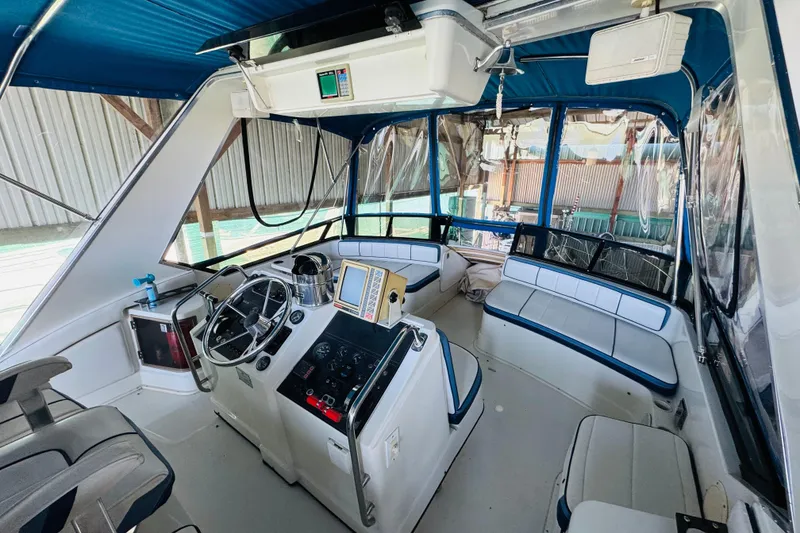 Slide: The Image of 1989 Carver 38 Santego boat interior with helm, seating, and navigation equipment. - 30