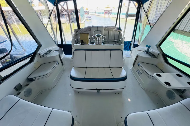 Slide: The Image of Interior of 1989 Carver 38 Santego yacht with white seating and helm view. - 33