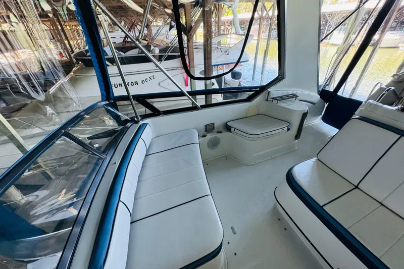 Slide: The Image of Interior view of 1989 Carver 38 Santego yacht with white seating and windows. - 34