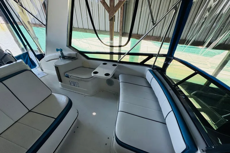 Slide: The Image of Interior of 1989 Carver 38 Santego yacht with white seating and windows. - 35
