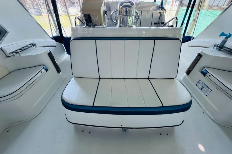 Slide: The Image of Interior of 1989 Carver 38 Santego yacht with white seating and helm station. - 36