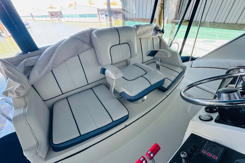Slide: The Image of Interior of a 1989 Carver 38 Santego yacht with white seating and helm controls. - 37
