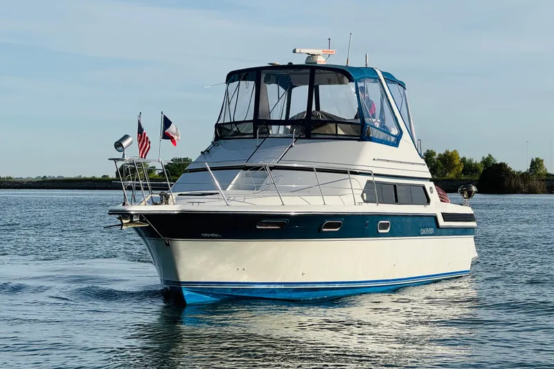 Slide: The Image of 1989 Carver 38 Santego yacht cruising on calm water under clear skies. - 4