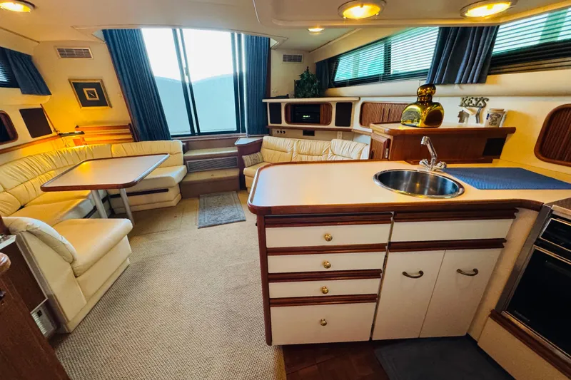 Slide: The Image of Interior of a 1989 Carver 38 Santego yacht with cozy seating and kitchenette. - 49