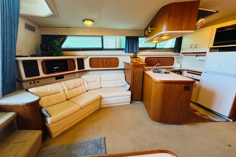 Slide: The Image of Interior of 1989 Carver 38 Santego yacht with cozy seating and kitchenette. - 52