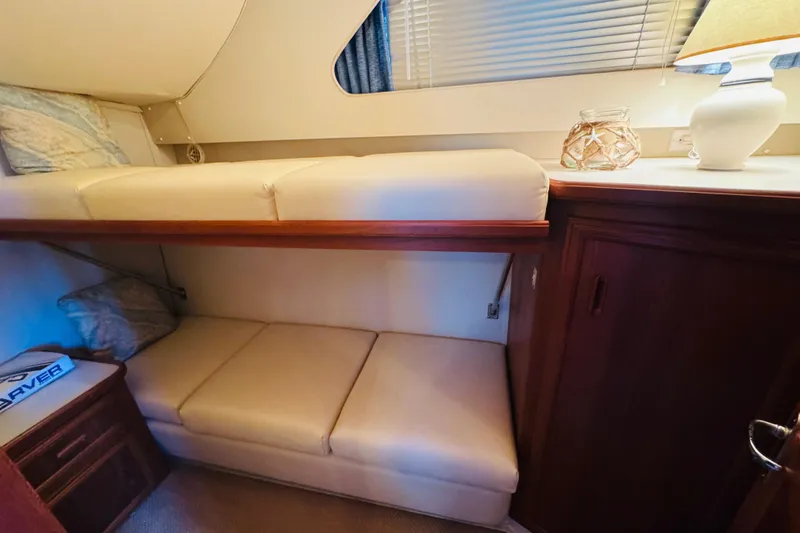 Slide: The Image of 1989 Carver 38 Santego cabin interior with bunk beds and wooden cabinetry. - 57