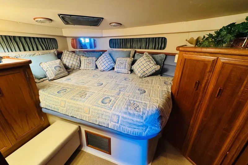 Slide: The Image of Cozy bedroom interior of 1989 Carver 38 Santego yacht with plush bedding and wooden cabinetry. - 58