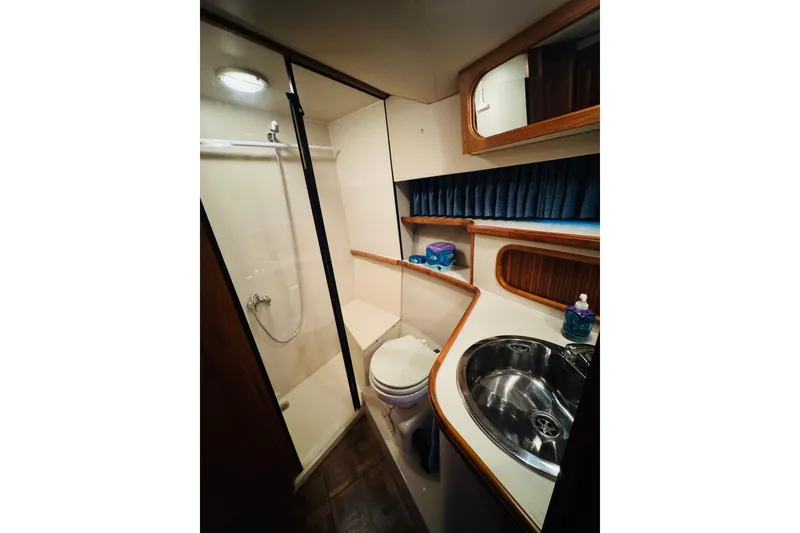 Slide: The Image of Bathroom interior of 1989 Carver 38 Santego yacht with shower, sink, and toilet. - 61