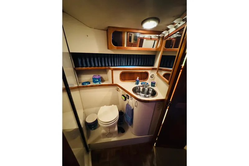 Slide: The Image of 1989 Carver 38 Santego yacht bathroom with sink, toilet, and wooden accents. - 62