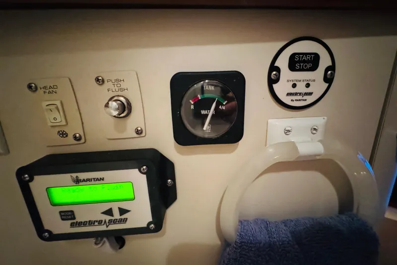 Slide: The Image of Control panel of a 1989 Carver 38 Santego boat with various switches and gauges. - 63