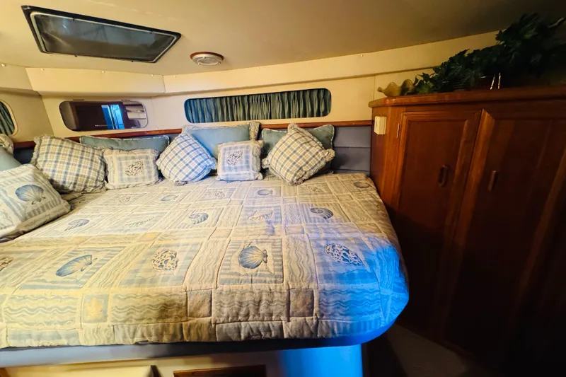 Slide: The Image of Cozy bedroom in 1989 Carver 38 Santego yacht with patterned bedding and wooden cabinets. - 64