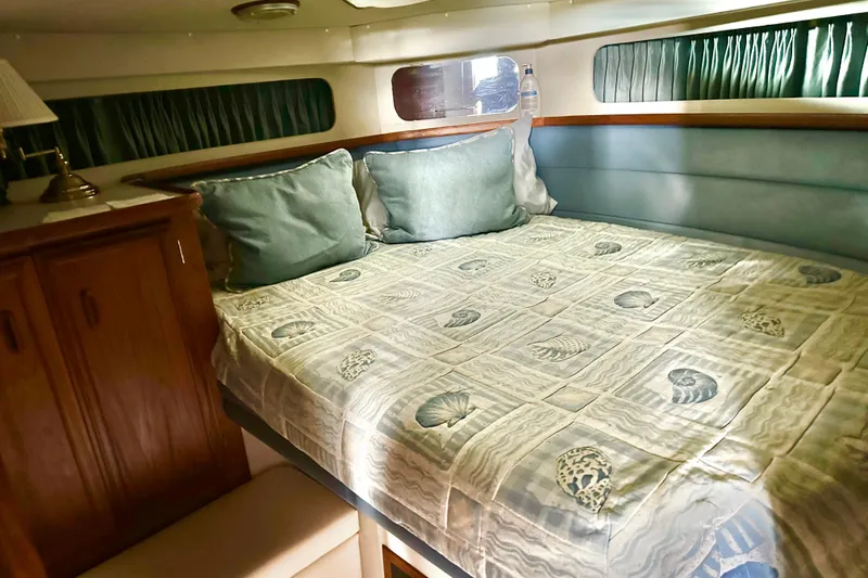 Slide: The Image of Cozy cabin interior of 1989 Carver 38 Santego with seashell-themed bedding. - 65