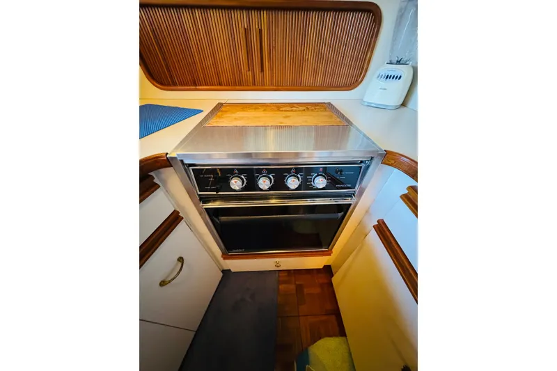 Slide: The Image of 1989 Carver 38 Santego yacht kitchen with stove and wooden cabinetry. - 67