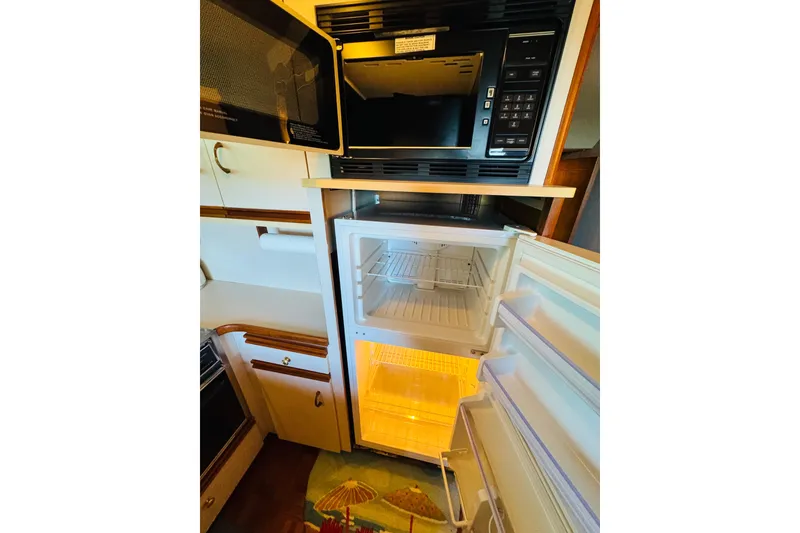 Slide: The Image of 1989 Carver 38 Santego kitchen with microwave and open refrigerator. - 70