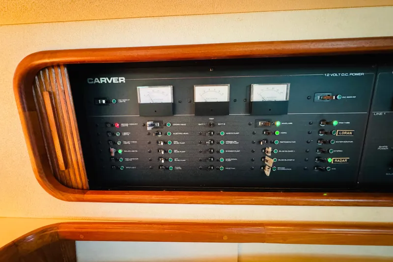 Slide: The Image of Control panel of a 1989 Carver 38 Santego boat, featuring gauges and switches. - 73