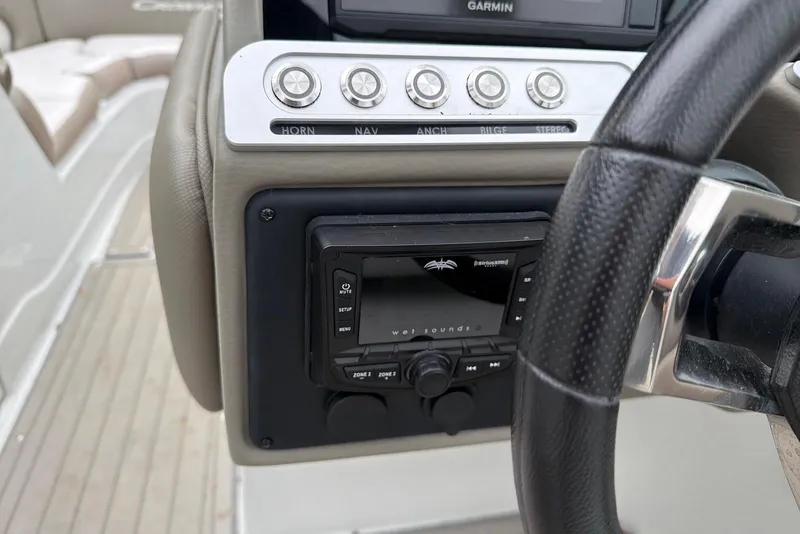 Slide: The Image of 2023 Crownline Eclipse E285 XS dashboard with controls and steering wheel. - 11