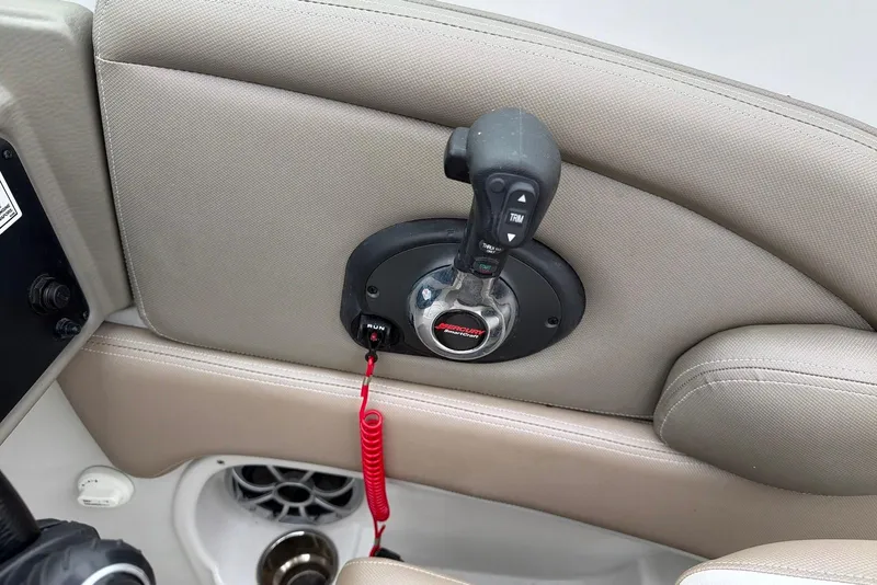 Slide: The Image of Throttle control of 2023 Crownline Eclipse E285 XS boat with beige interior. - 12