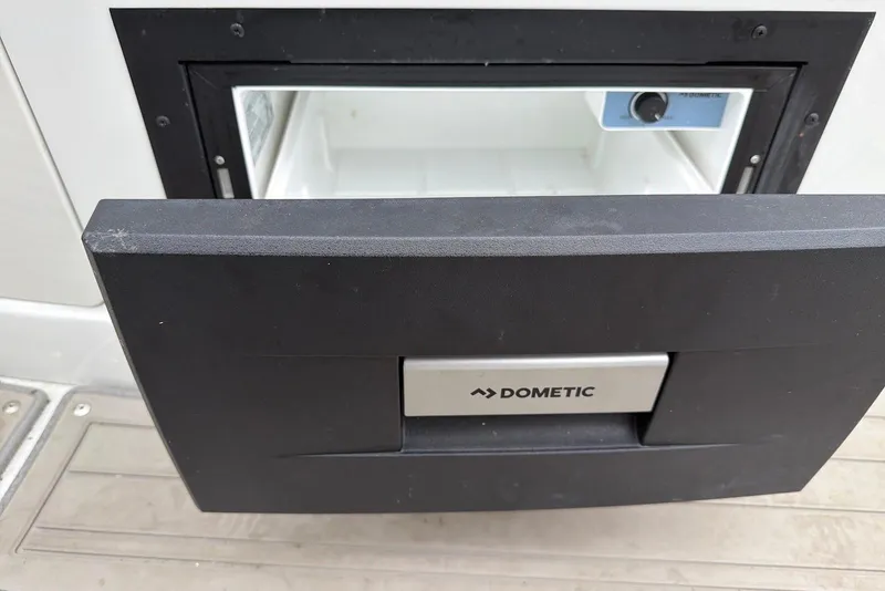 Slide: The Image of Dometic refrigerator in 2023 Crownline Eclipse E285 XS boat, partially open. - 15