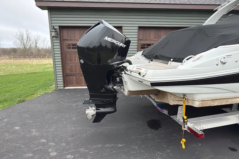 Slide: The Image of 2023 Crownline Eclipse E285 XS boat with Mercury outboard motor on trailer. - 17