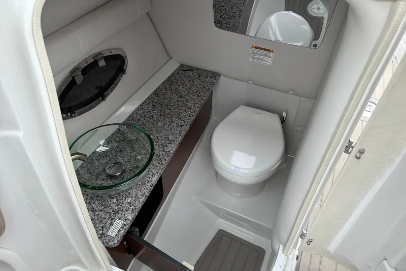 Slide: The Image of 2023 Crownline Eclipse E285 XS boat bathroom with modern sink and toilet. - 21