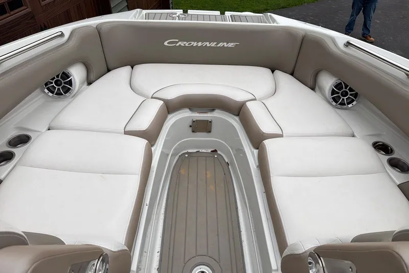 Slide: The Image of 2023 Crownline Eclipse E285 XS boat interior with cushioned seating and cup holders. - 8