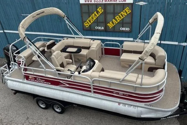 The Image of 2019 Sun Tracker SportFish 22 DLX pontoon boat with beige seating and dual bimini tops. - 0