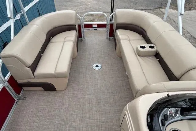 Slide: The Image of 2019 Sun Tracker SportFish 22 DLX pontoon boat interior with beige seating and console. - 10