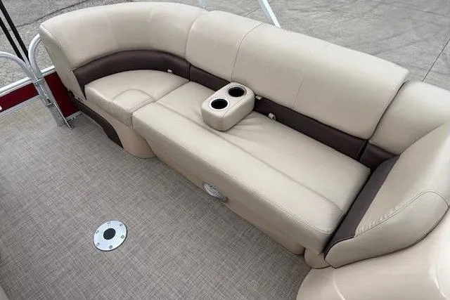 Slide: The Image of 2019 Sun Tracker SportFish 22 DLX pontoon boat interior with beige seating and cup holders. - 11