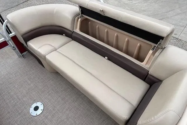 Slide: The Image of 2019 Sun Tracker SportFish 22 DLX boat interior with beige seating and storage compartment. - 12