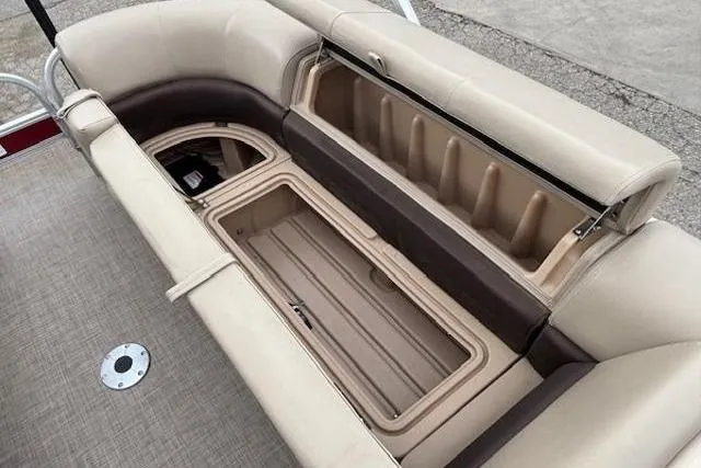 Slide: The Image of 2019 Sun Tracker SportFish 22 DLX boat seating with storage compartments open. - 13