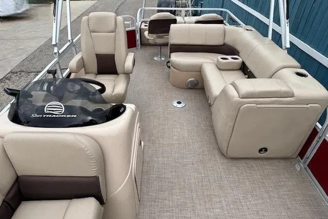 Slide: The Image of 2019 Sun Tracker SportFish 22 DLX pontoon boat with beige seating and spacious layout. - 16