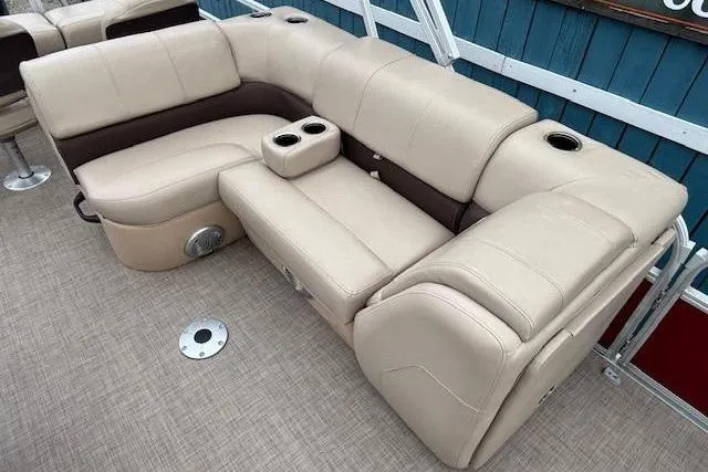 Slide: The Image of 2019 Sun Tracker SportFish 22 DLX boat seating with beige upholstery and cup holders. - 17