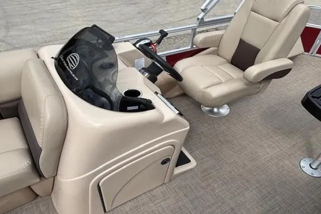 Slide: The Image of 2019 Sun Tracker SportFish 22 DLX boat interior with beige captain's chair and console. - 21