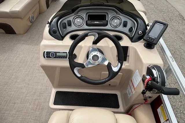 Slide: The Image of 2019 Sun Tracker SportFish 22 DLX boat dashboard with steering wheel and control panel. - 22