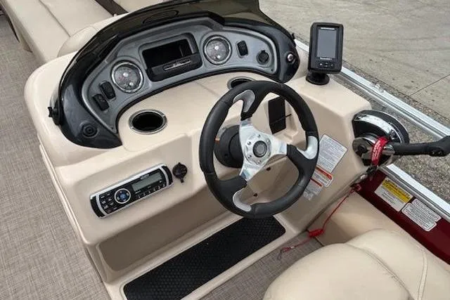Slide: The Image of 2019 Sun Tracker SportFish 22 DLX boat dashboard with steering wheel and control panel. - 23