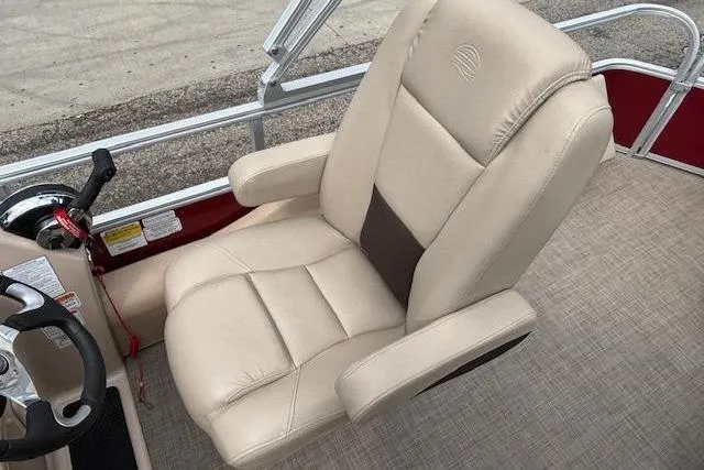 Slide: The Image of 2019 Sun Tracker SportFish 22 DLX boat seat, beige upholstery, steering wheel, and control panel. - 24