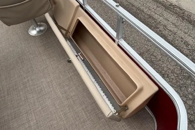 Slide: The Image of 2019 Sun Tracker SportFish 22 DLX boat interior storage compartment with beige upholstery. - 26